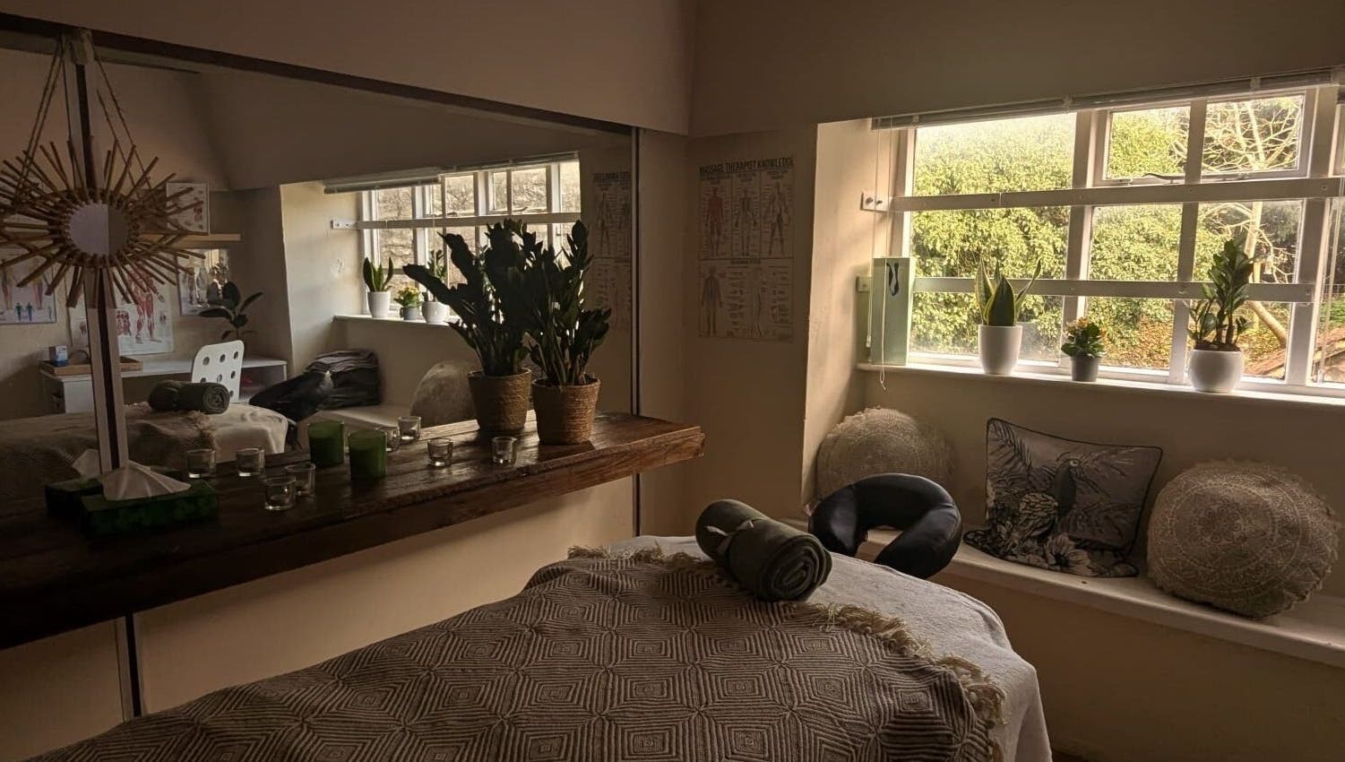 Serene massage room at Lexa Massage Studio in Keynsham, England, GB with cozy decor and natural light.