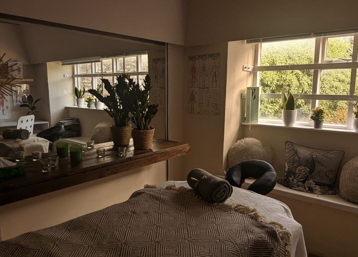 Serene massage room at Lexa Massage Studio in Keynsham, England, GB with cozy decor and natural light.