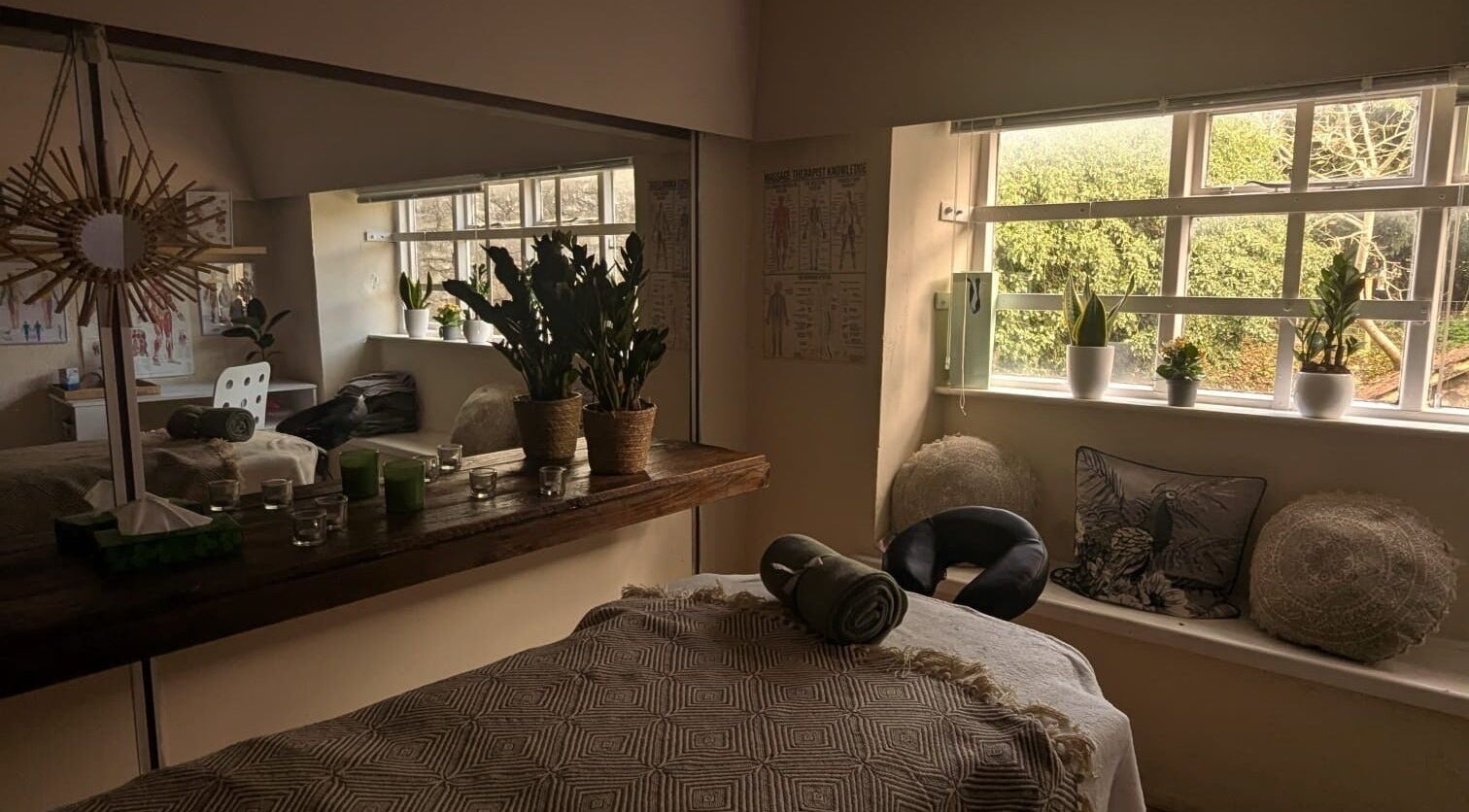 Serene massage room at Lexa Massage Studio in Keynsham, England, GB with cozy decor and natural light.