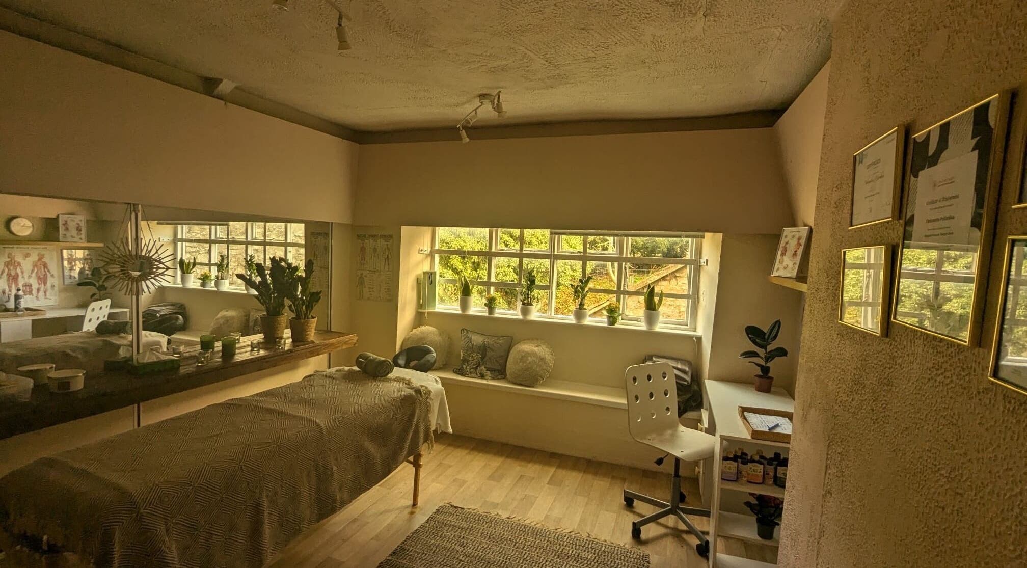 Relaxing massage room at Lexa Massage Studio, Keynsham, England, featuring calming decor and natural light.