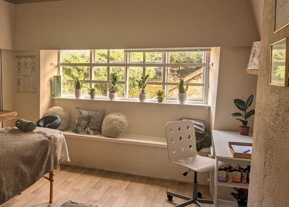 Cozy massage room at Lexa Massage Studio in Keynsham, England, GB featuring a tranquil ambiance with plants.