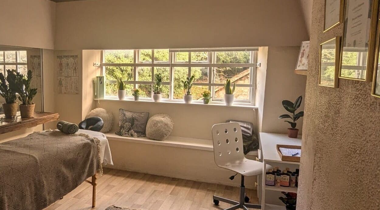 Cozy massage room at Lexa Massage Studio in Keynsham, England, GB featuring a tranquil ambiance with plants.