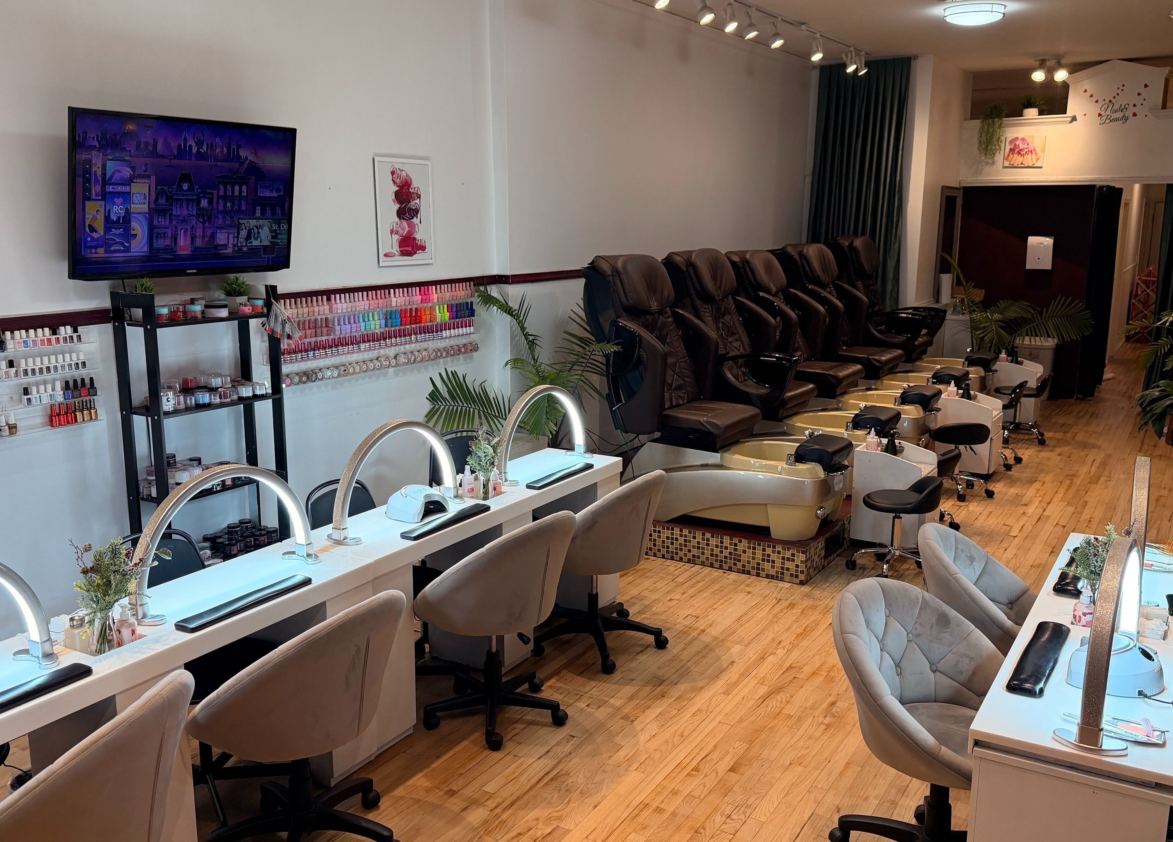 Modern nail salon interior at The Nail Bar on Division in Chicago, Illinois, US with plush seating and polish display.