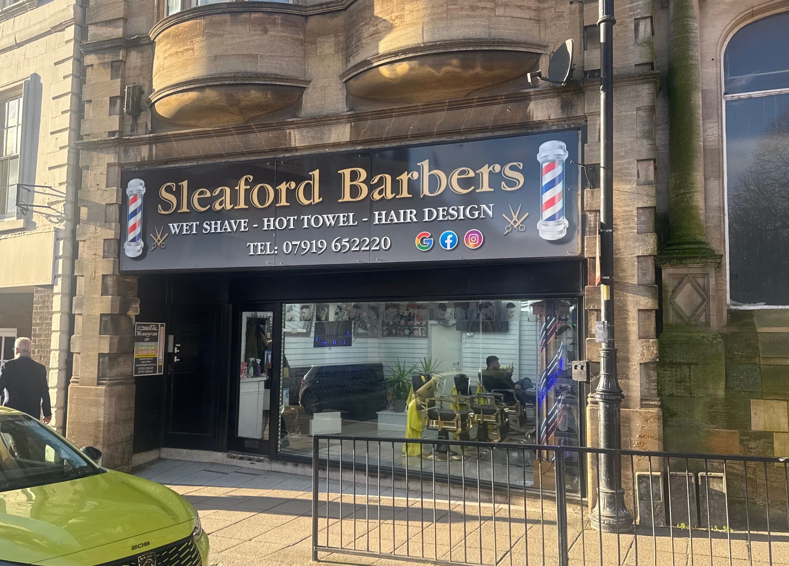 Exterior of Sleaford Barbers in London, England, GB showcasing modern signage and inviting storefront.