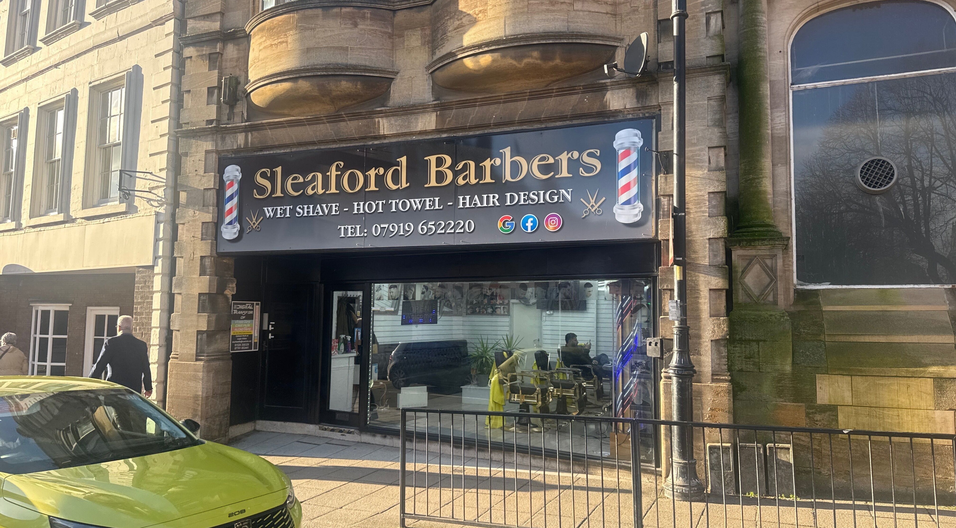Exterior of Sleaford Barbers in London, England, GB showcasing modern signage and inviting storefront.