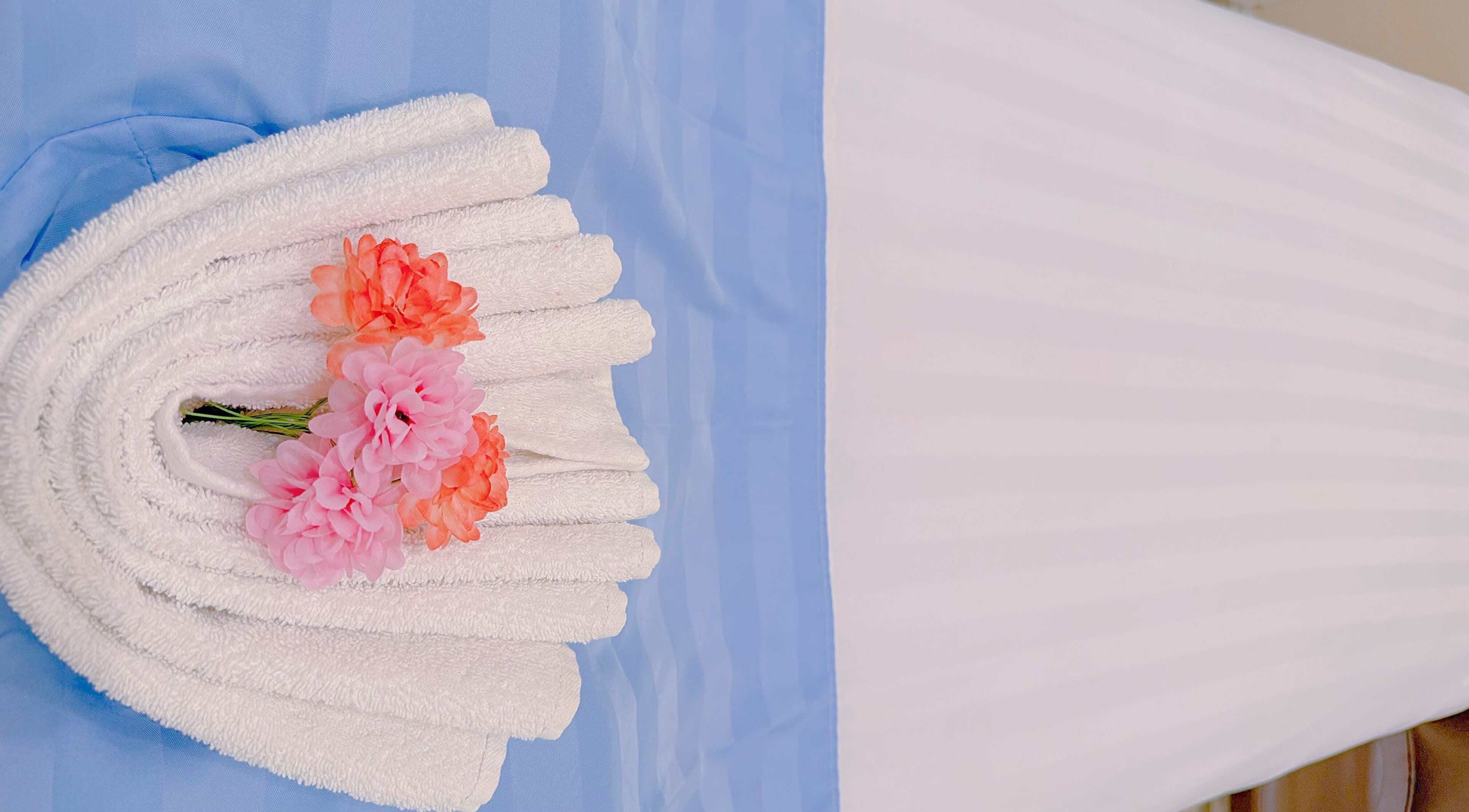 Elegant towel display with flowers at Cici Lash Brow & Hair Studio, Torrance, California, US.