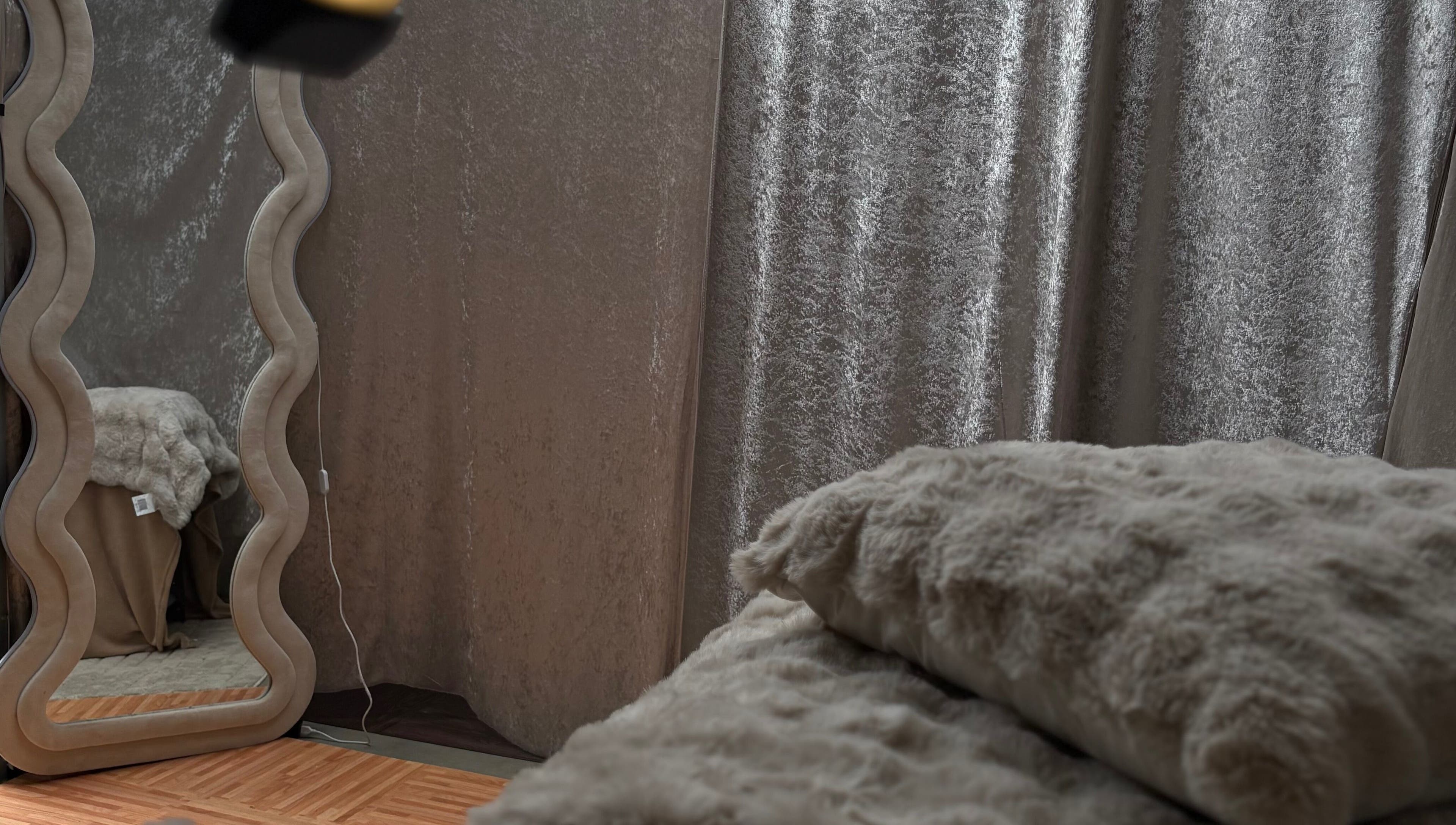 Inviting space at Lashed By Mirai in Ravenswood, Tasmania with elegant mirror and plush decor.