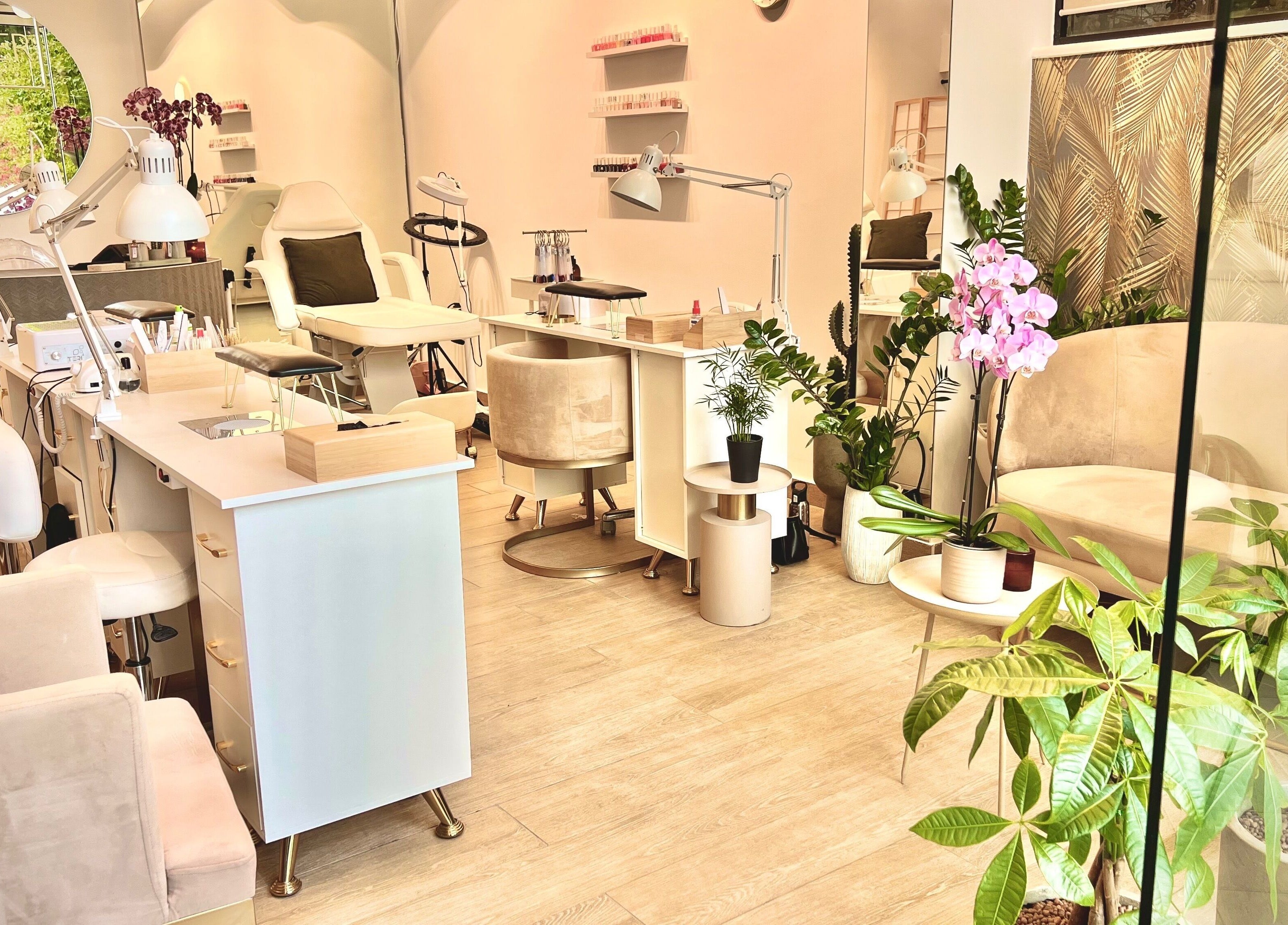 Interior of Aether beauty nails, Glifada, GR, featuring chic manicuring stations and lush greenery.