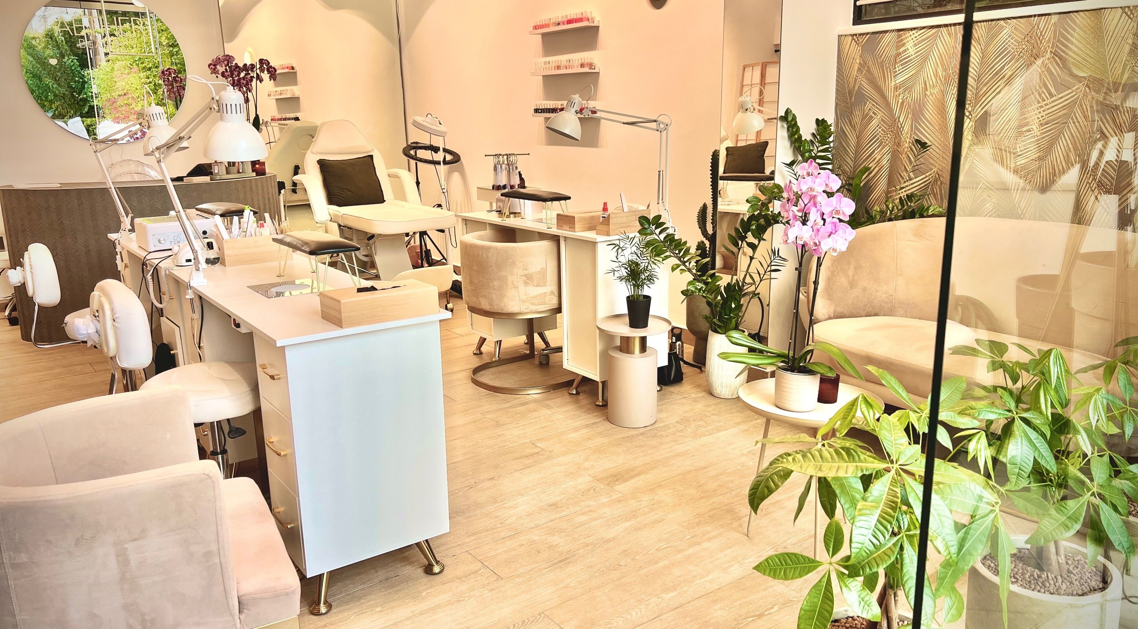 Interior of Aether beauty nails, Glifada, GR, featuring chic manicuring stations and lush greenery.