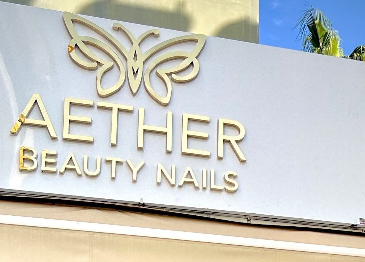 Elegant butterfly sign of Aether Beauty Nails in Glifada, GR, welcoming visitors.
