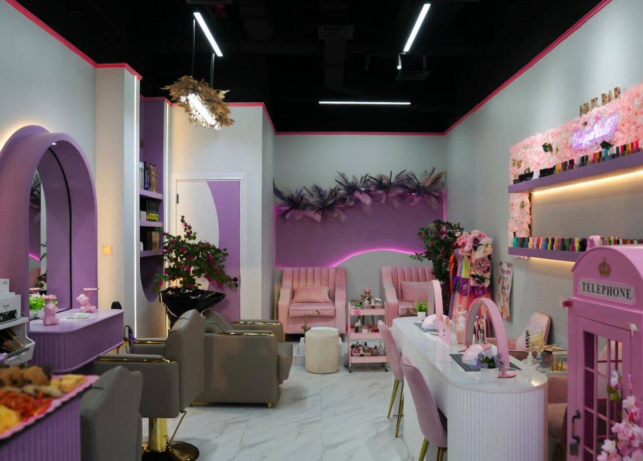 Chic interior of Unique Station Beauty Salon in Dubai, AE, featuring elegant lavender decor and plush seating.