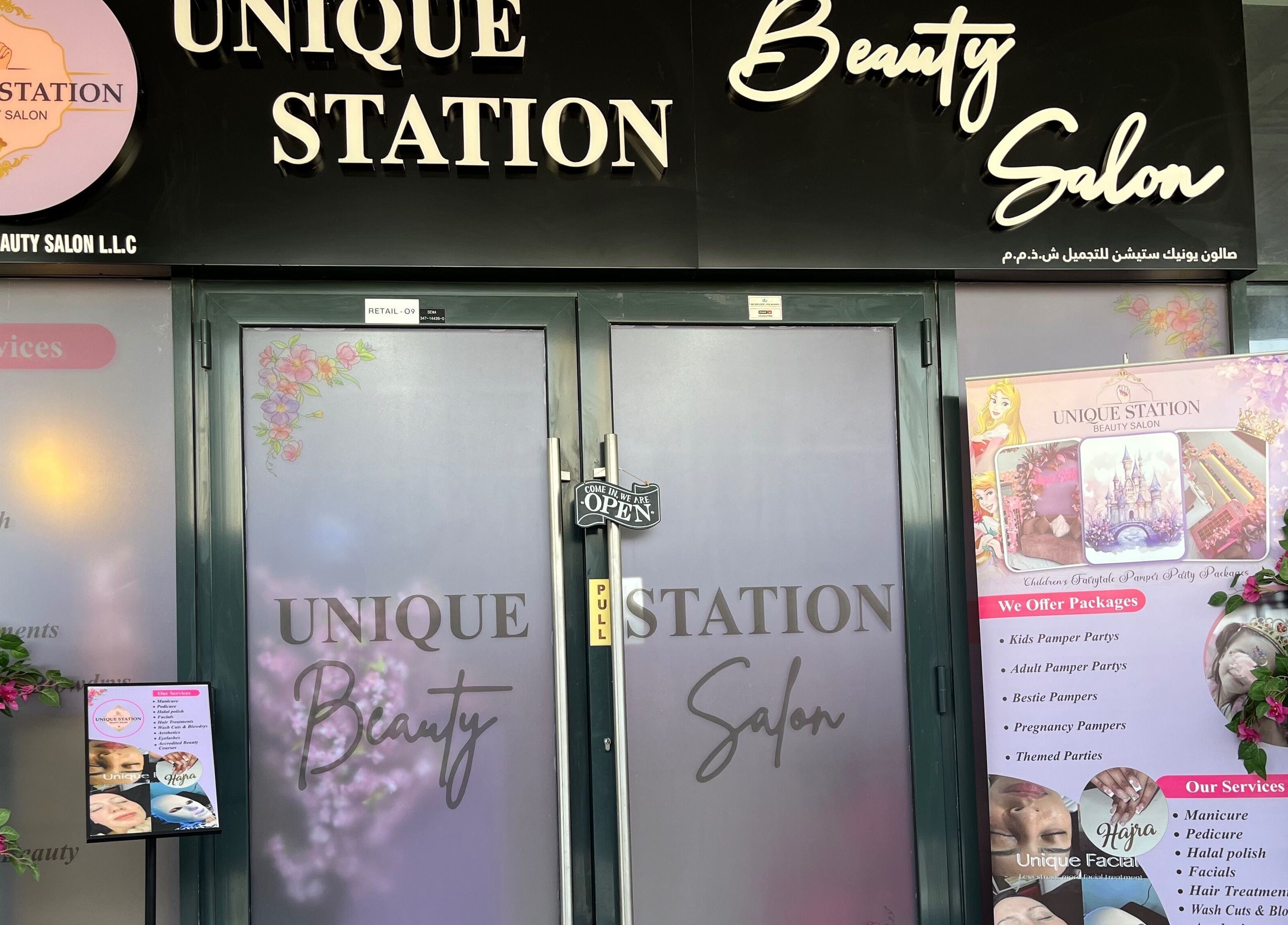 Front view of Unique Station Beauty Salon in Dubai, AE featuring services menu and welcoming decor.