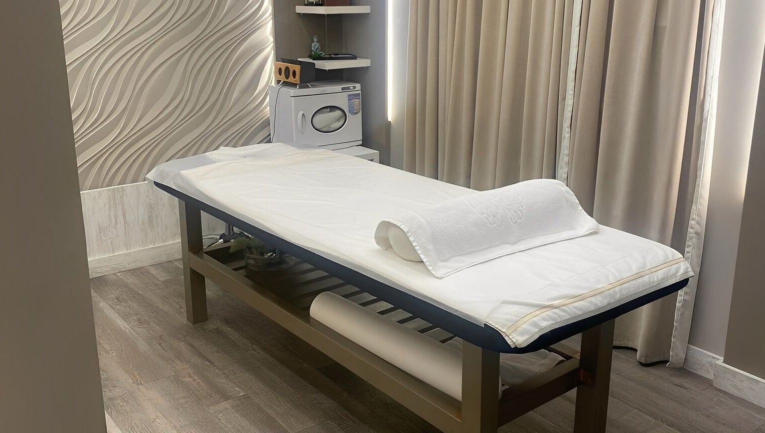 Relaxing treatment room at Firgunwellness Yerevan, Yerevan, AM with massage table and tranquil decor.