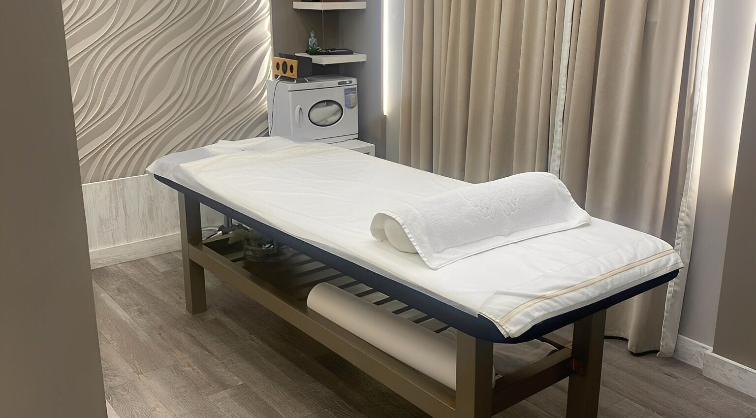 Relaxing treatment room at Firgunwellness Yerevan, Yerevan, AM with massage table and tranquil decor.