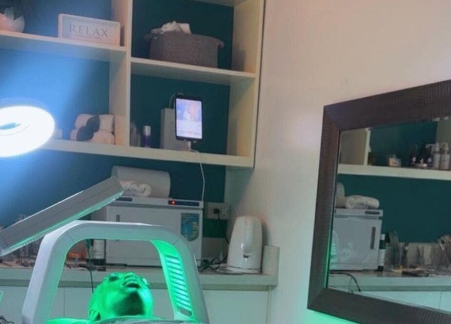 Relaxing treatment room at Unblemished By Tish (Anguilla) in The Valley, AI with calming green lighting.