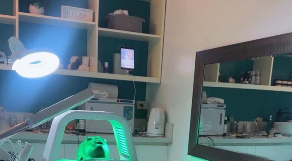 Relaxing treatment room at Unblemished By Tish (Anguilla) in The Valley, AI with calming green lighting.