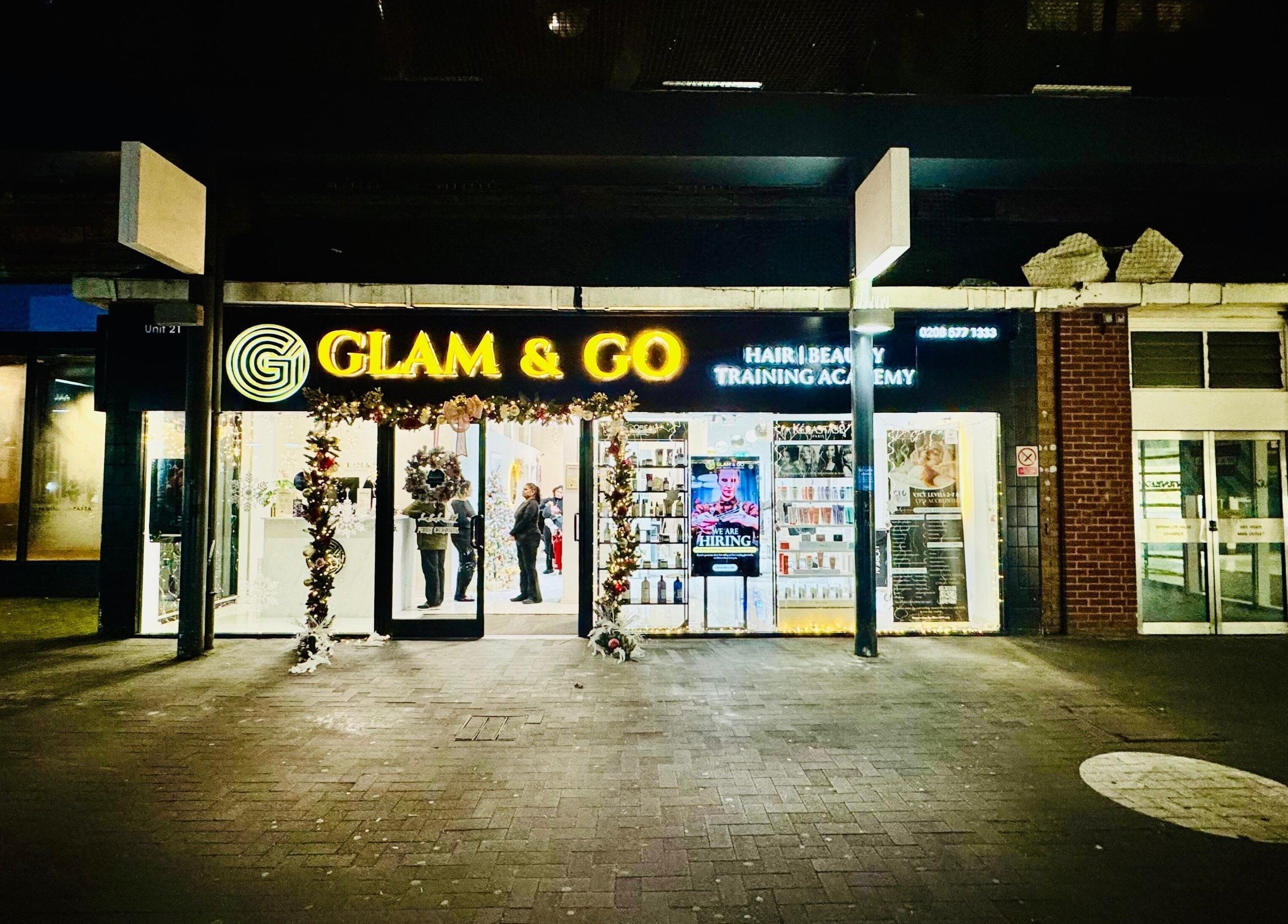 Glam & Go Hounslow entrance lit at night, showcasing beauty services in Hounslow, England, GB.