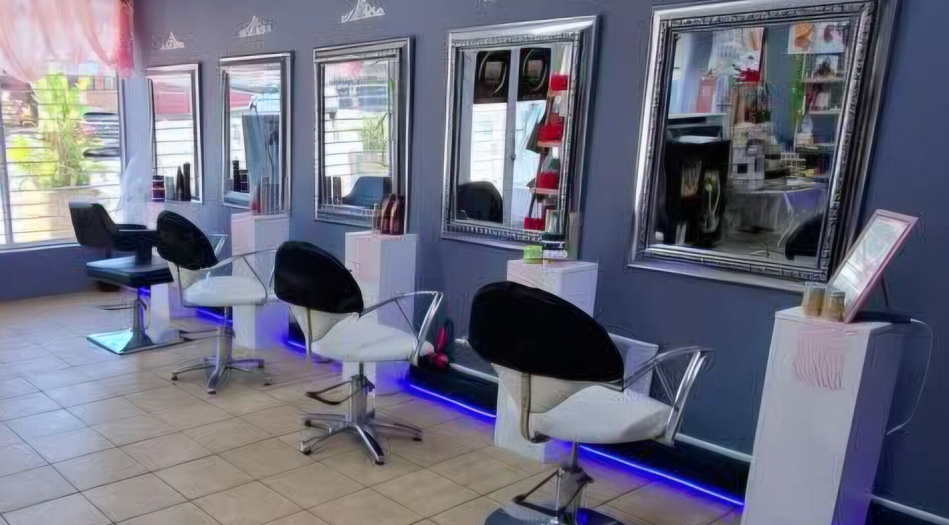 Elegant salon interior at Hair by Elle in Cape Town, Western Cape, ZA featuring stylish mirrors and seating.