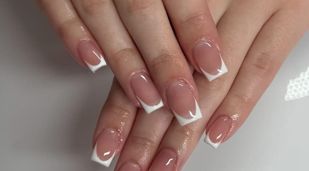 Elegant French manicure at Beauty Bar Kent, Maidstone, England, GB showcasing glossy white-tipped nails.