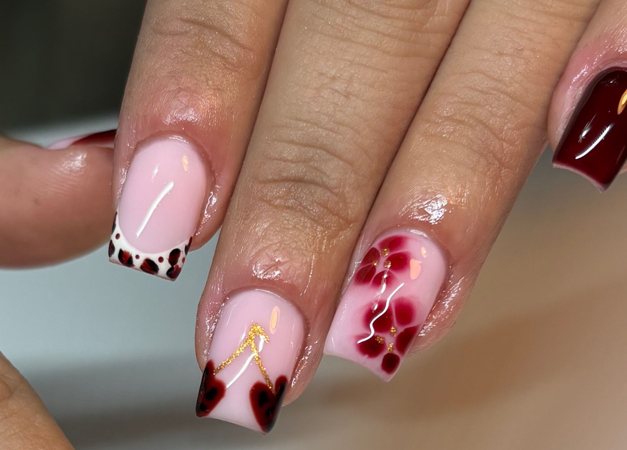 Intricate nail art at Paint Them Nails With Amina in Stoke-on-Trent, England, GB showcasing floral and geometric designs.