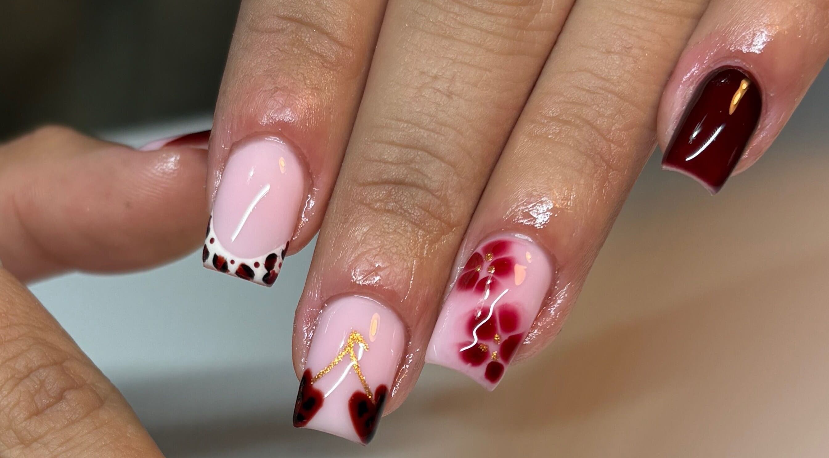Intricate nail art at Paint Them Nails With Amina in Stoke-on-Trent, England, GB showcasing floral and geometric designs.