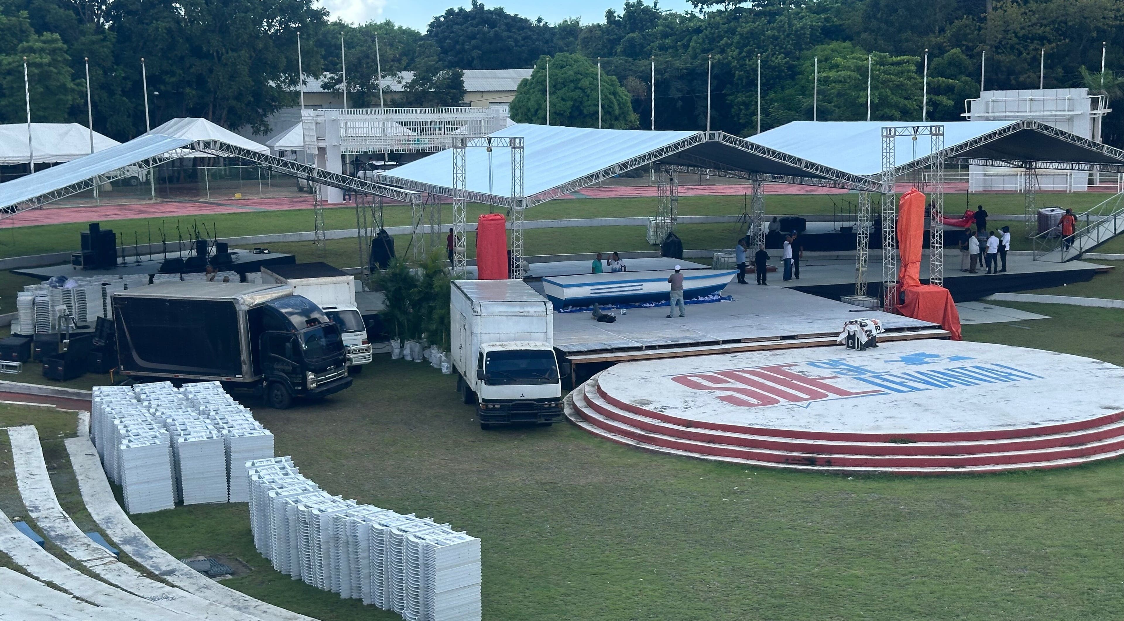 Stage setup at AGEO MATOS, Santo Domingo Este, Santo Domingo, DO, with trucks and tents.