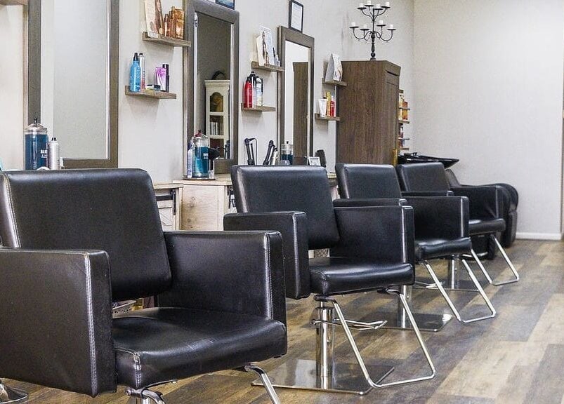 Modern styling chairs at Meraki Salon, Port St. Lucie, Florida, US, showcasing a sleek and inviting ambiance.