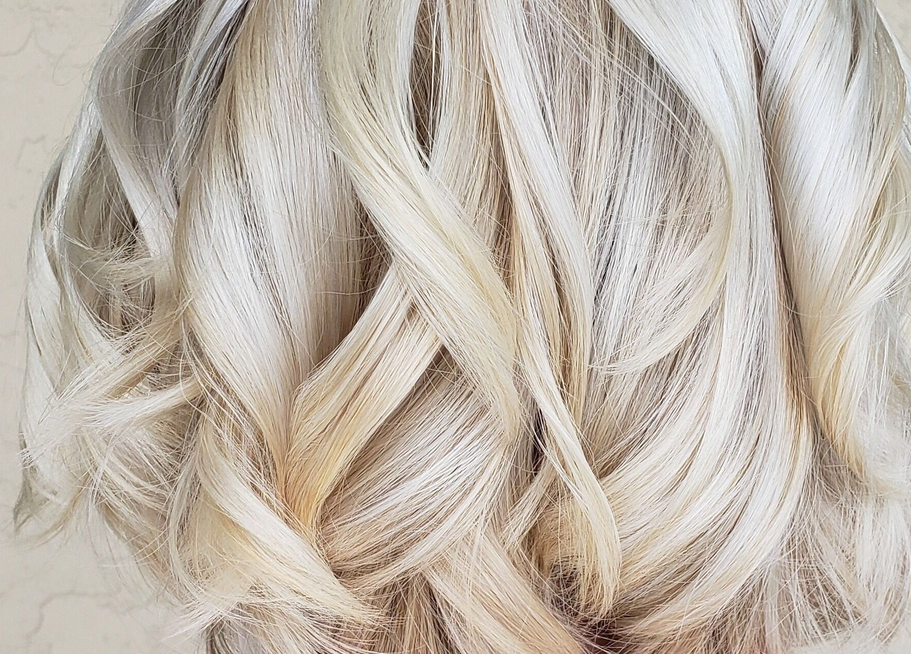 Elegant platinum blonde waves styled at Meraki Salon in Port St. Lucie, Florida, US.