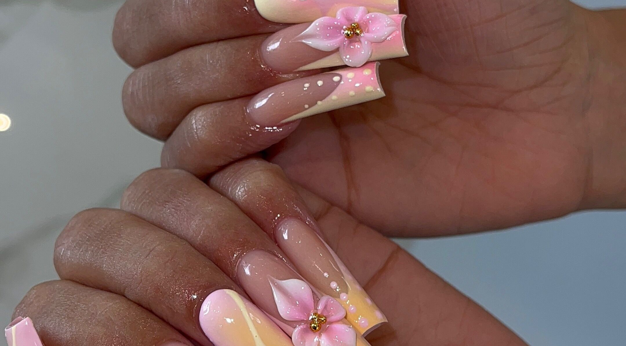 Elegant floral nail art at LAMIA NAILS PLANTATION in Sunrise, Florida, US featuring intricate pink designs.