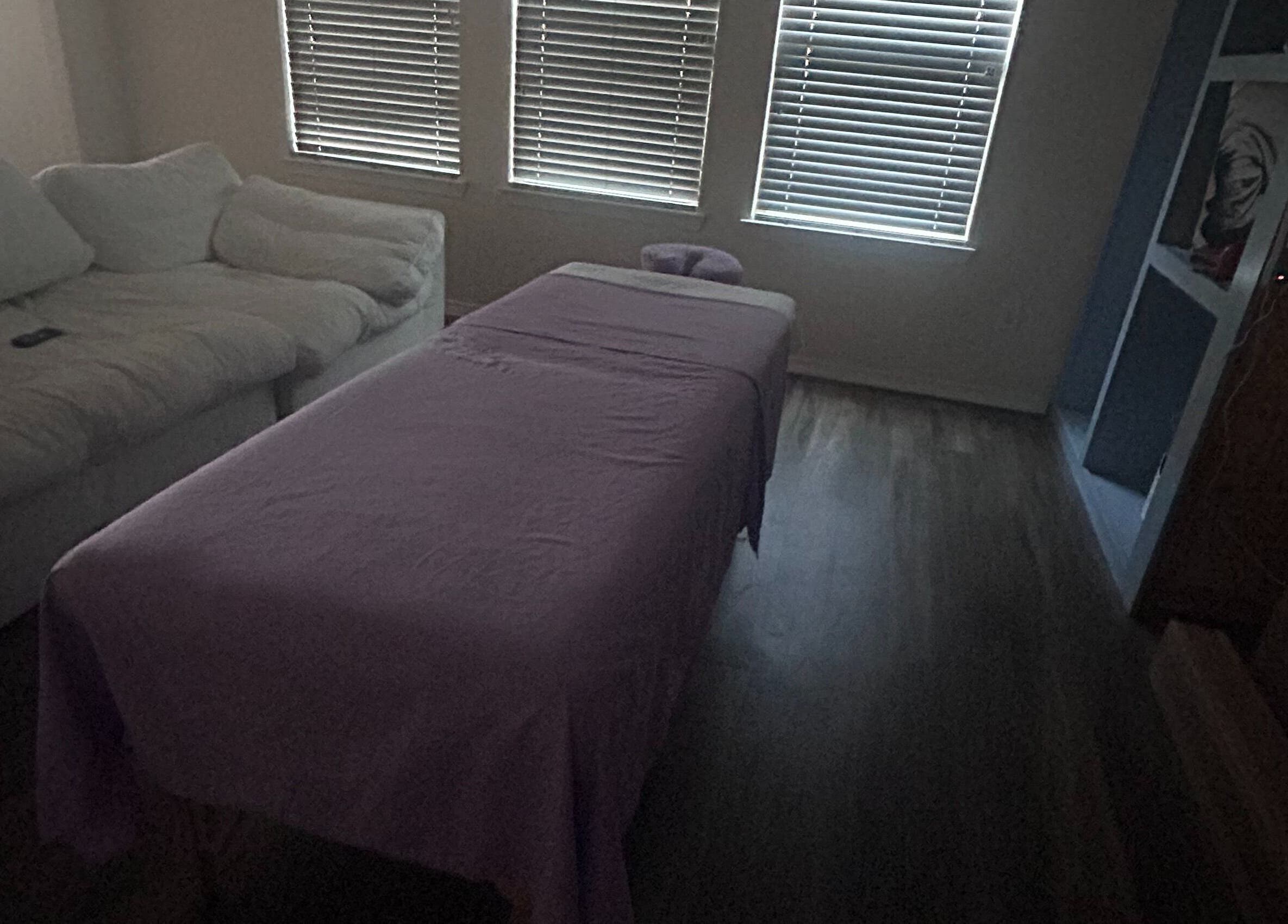 Relaxing massage setup at Mindful Motion Mobile Massage, US with cozy bed and serene ambiance.