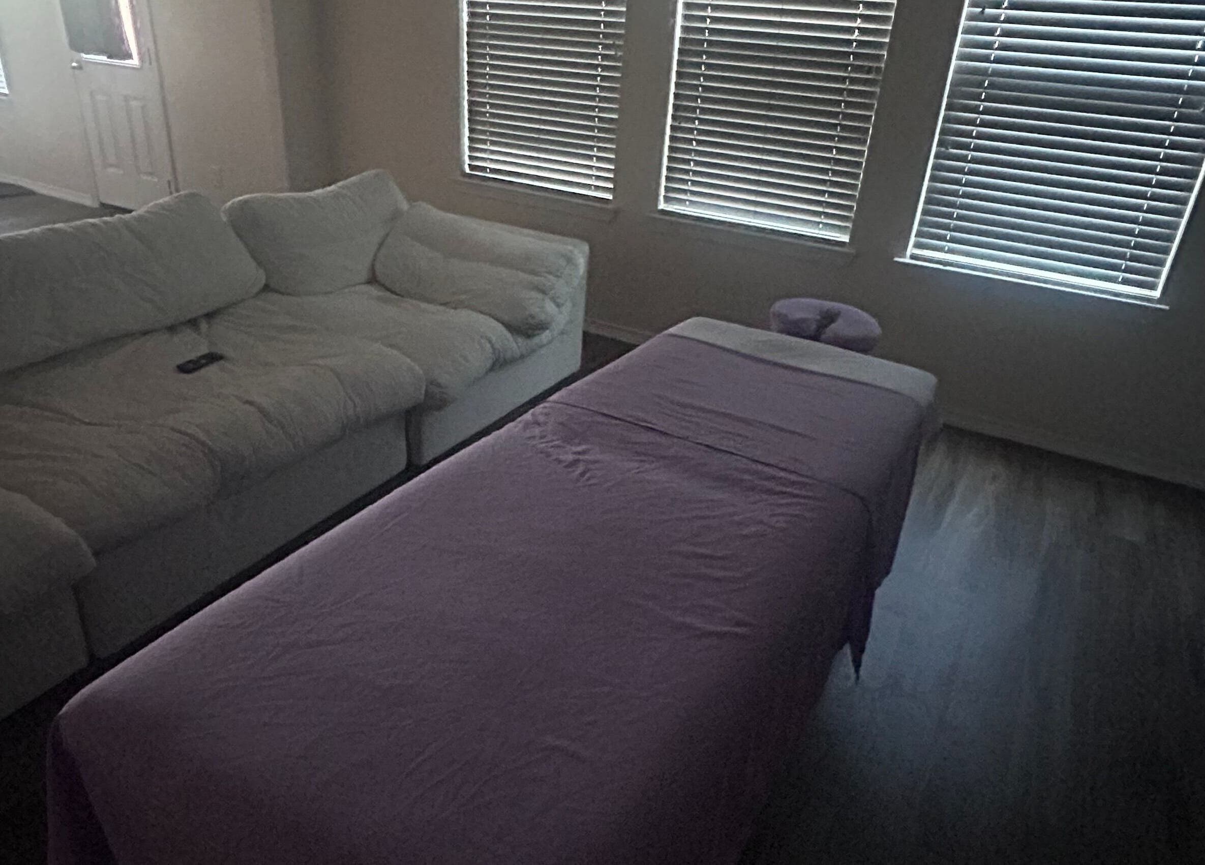 Cozy massage setup at Mindful Motion Mobile Massage, US with sofa and massage table.