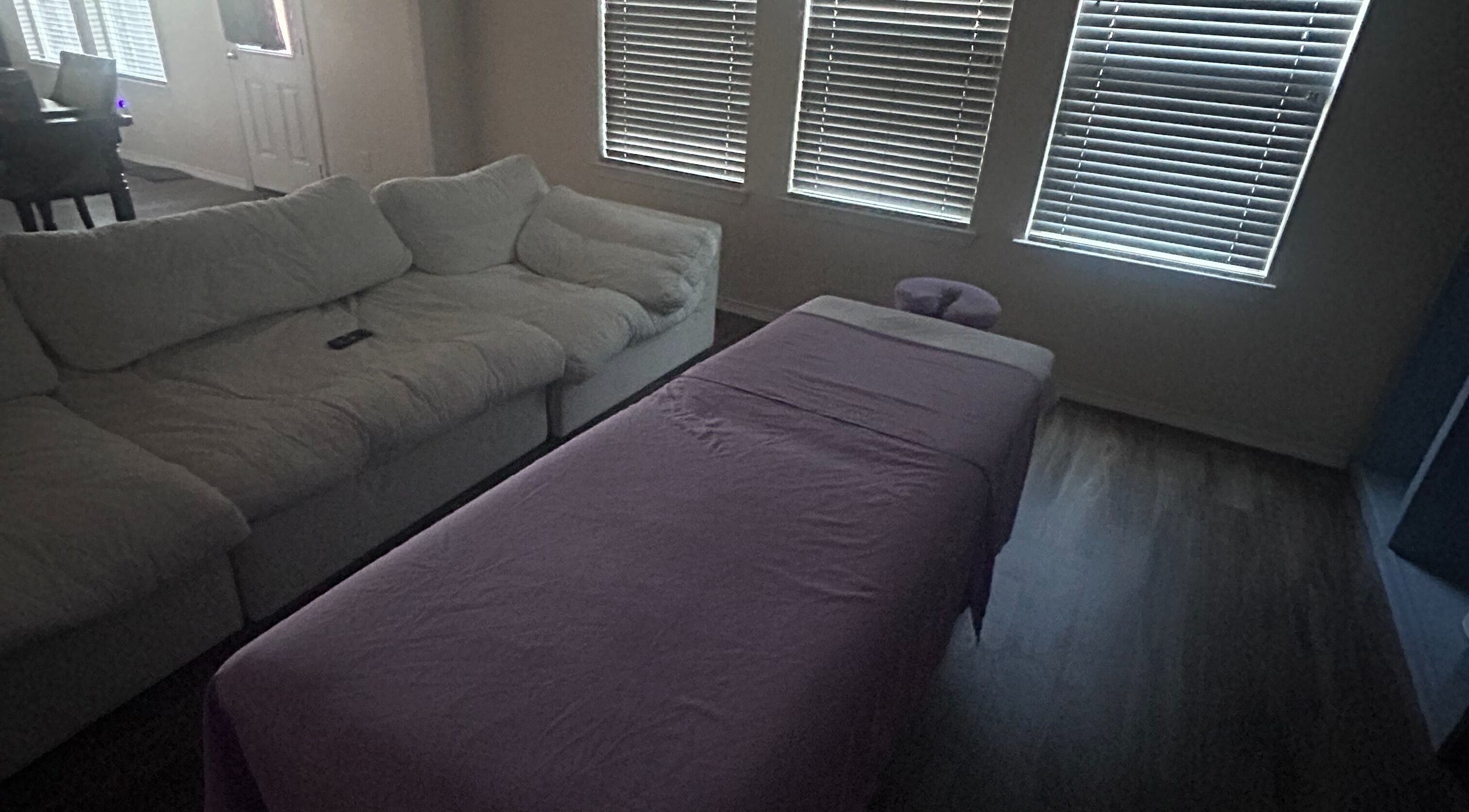 Cozy massage setup at Mindful Motion Mobile Massage, US with sofa and massage table.