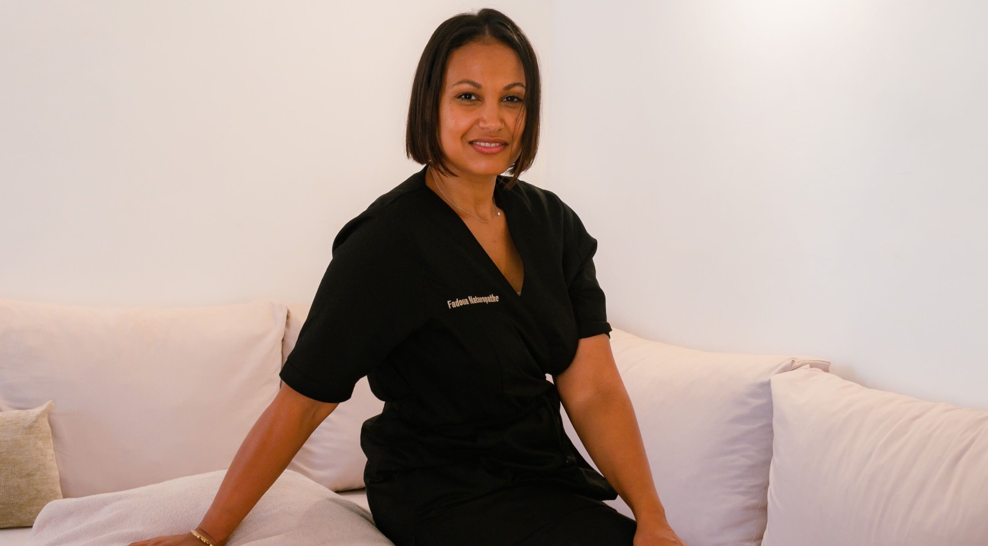 FADOUA SAMB, thérapeute experte à Dakar, Région De Dakar, SN, posée sereinement sur un canapé blanc.