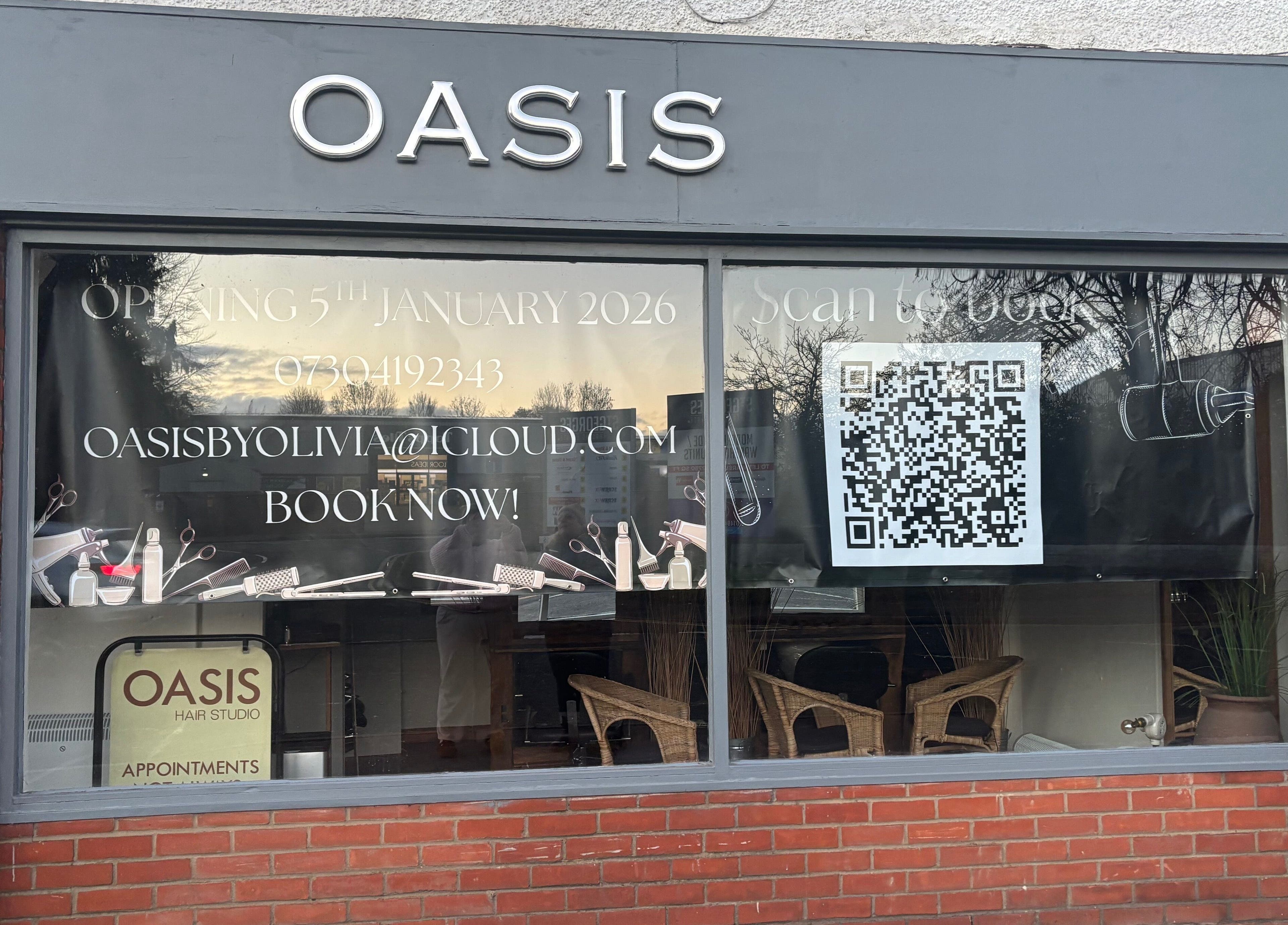 Front view of Oasis storefront in Amersham, England, GB, featuring booking details and a large QR code.