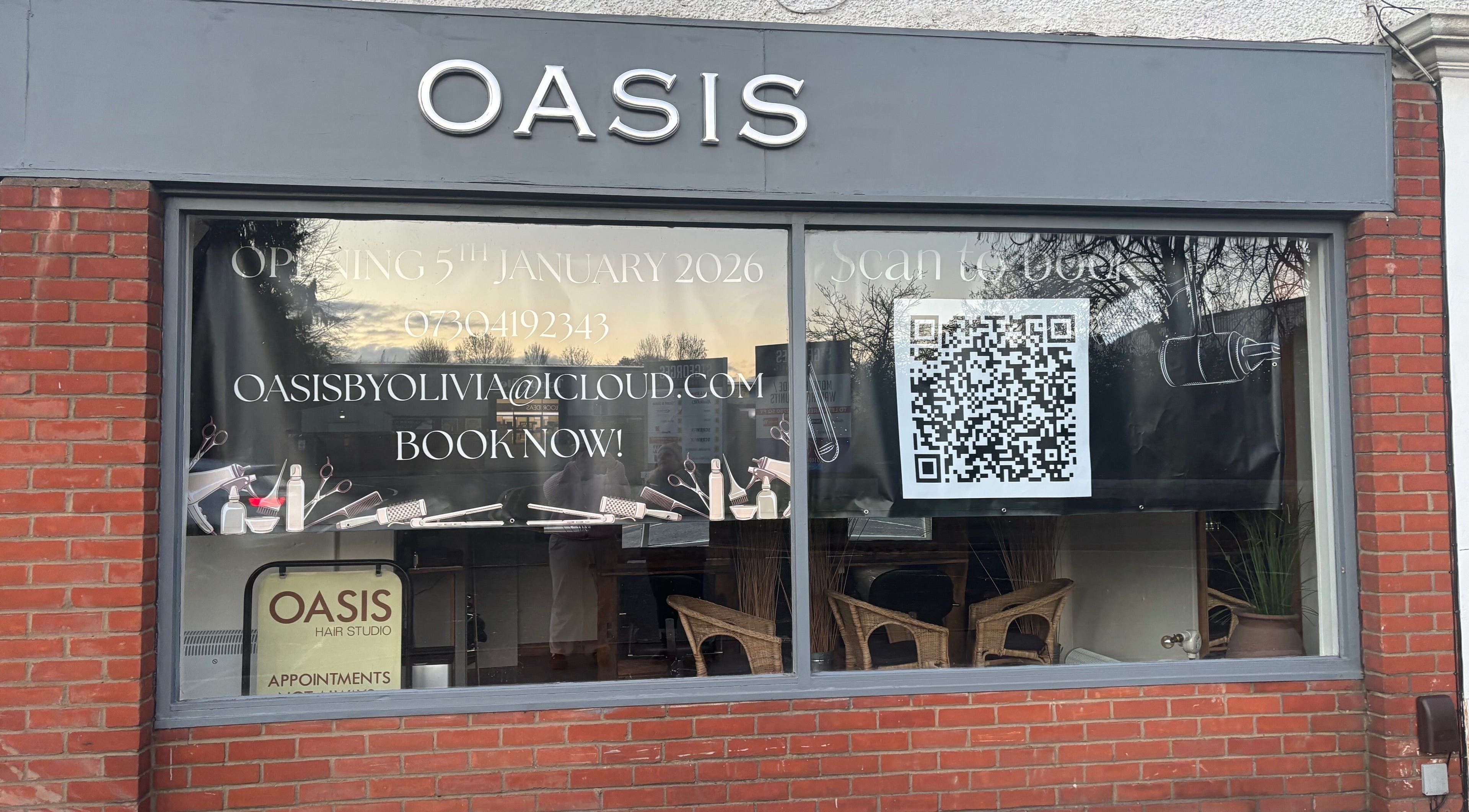 Front view of Oasis storefront in Amersham, England, GB, featuring booking details and a large QR code.