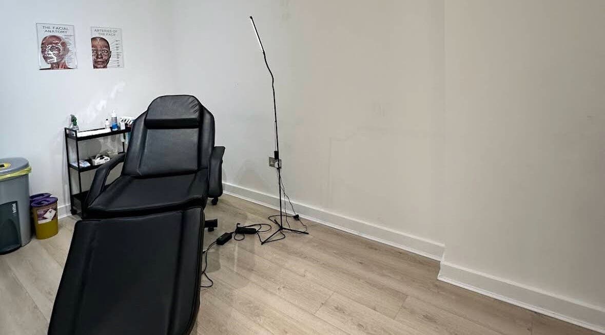 Comfortable treatment room at MavenAesthetics, London, England, GB, featuring a black recliner chair.