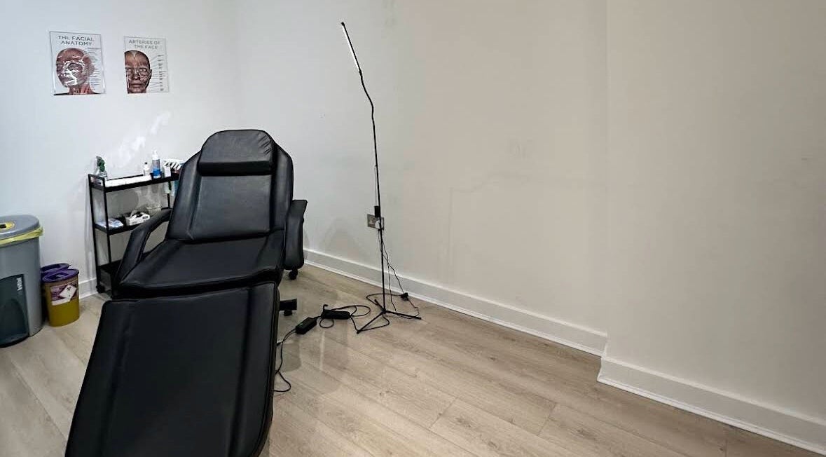 Comfortable treatment room at MavenAesthetics, London, England, GB, featuring a black recliner chair.
