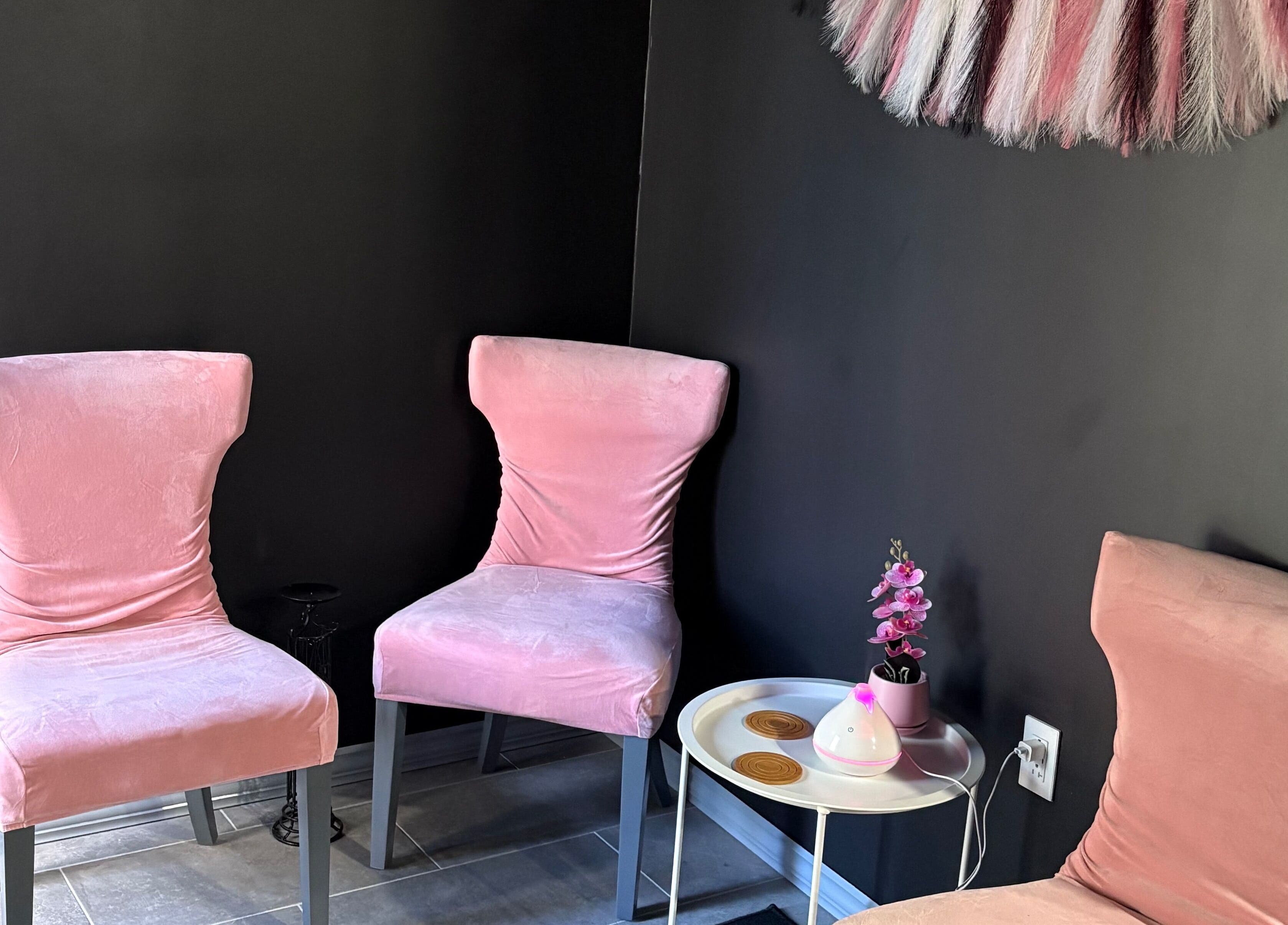 Cozy pink seating area at Contoured Crowns By Neky, Nassau, New Providence, BS. Perfect relaxation spot.