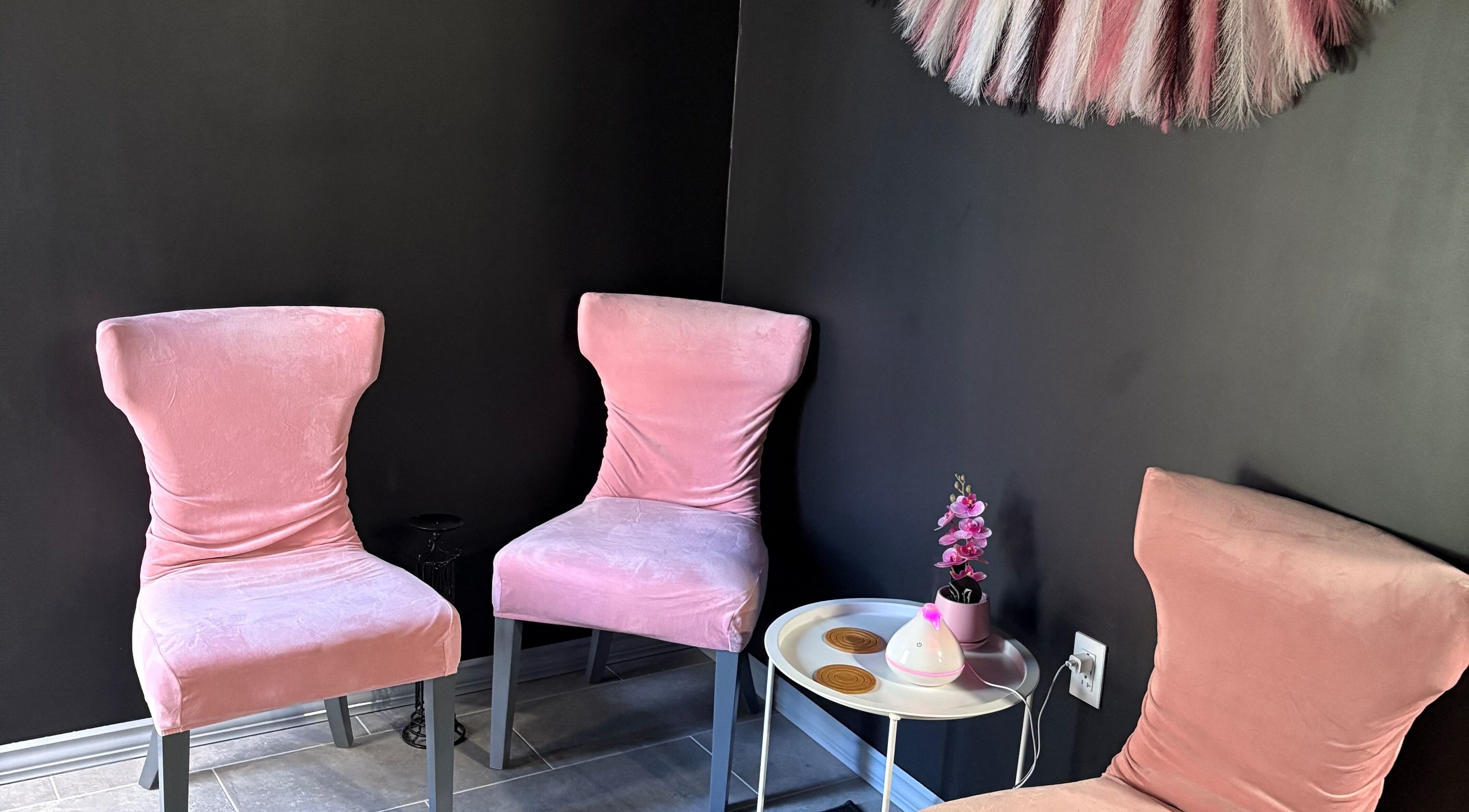 Cozy pink seating area at Contoured Crowns By Neky, Nassau, New Providence, BS. Perfect relaxation spot.