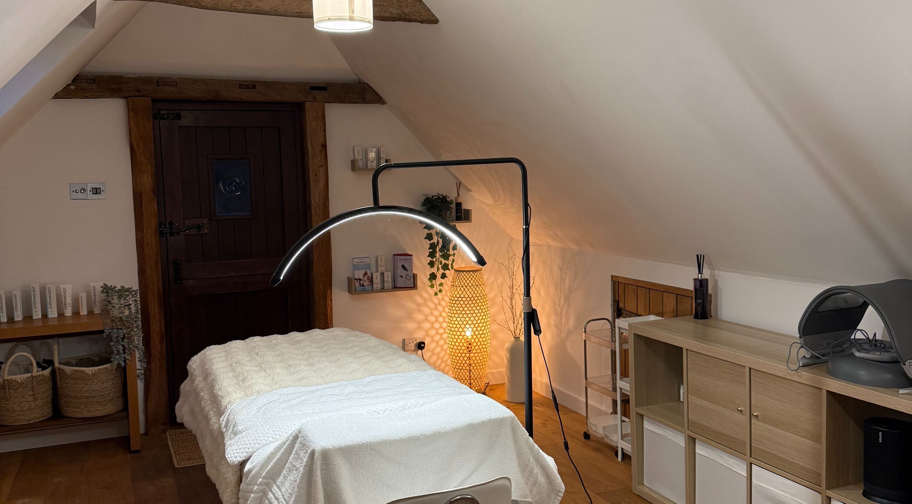 Tranquil treatment room at Jewell Aesthetics, Reading, England, GB, featuring a massage table and warm lighting.