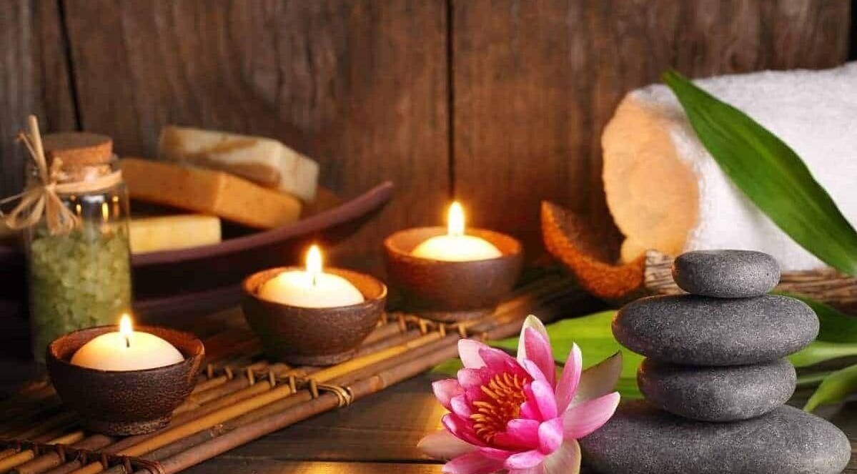 Calming spa scene with candles and stones at ONA SPA, Al Khobar, Eastern Province, SA.