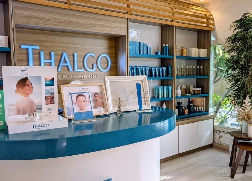 Reception area of Villa Thalgo - Dubai, showcasing luxury skincare displays and elegant decor in Dubai, AE.