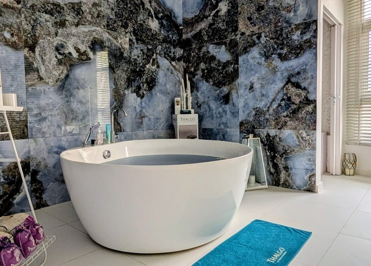 Luxurious bathroom at Villa Thalgo - Dubai, AE with modern bath and elegant decor.