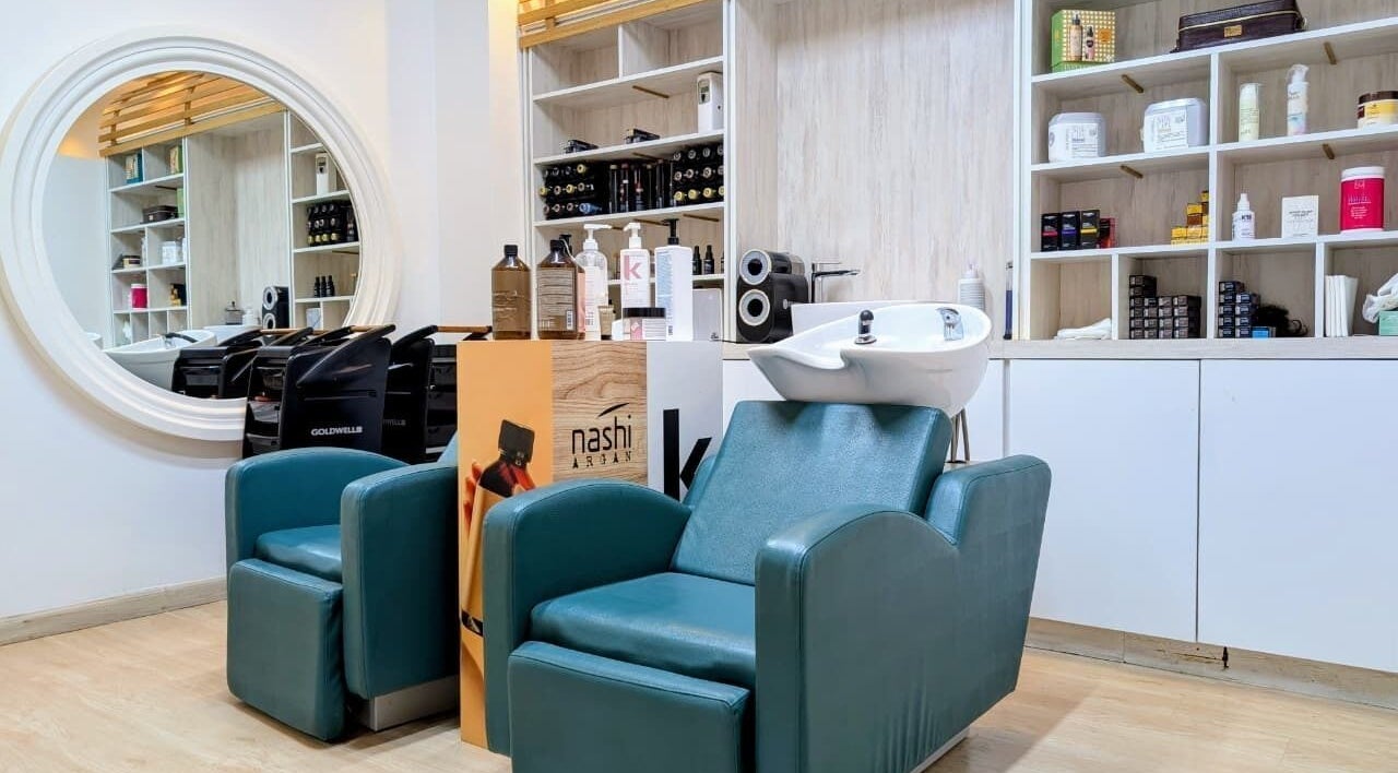 Hair salon area at Villa Thalgo - Dubai, featuring plush chairs and elegant styling tools. Located in Dubai, AE.