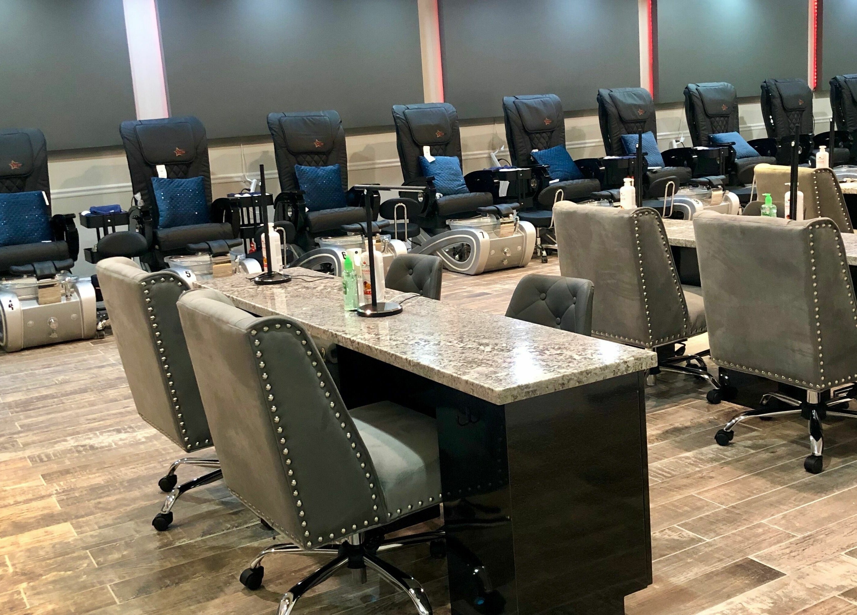 Upscale nail salon interior at Glo Nails, Houston, Texas, US featuring plush chairs and sleek nail stations.