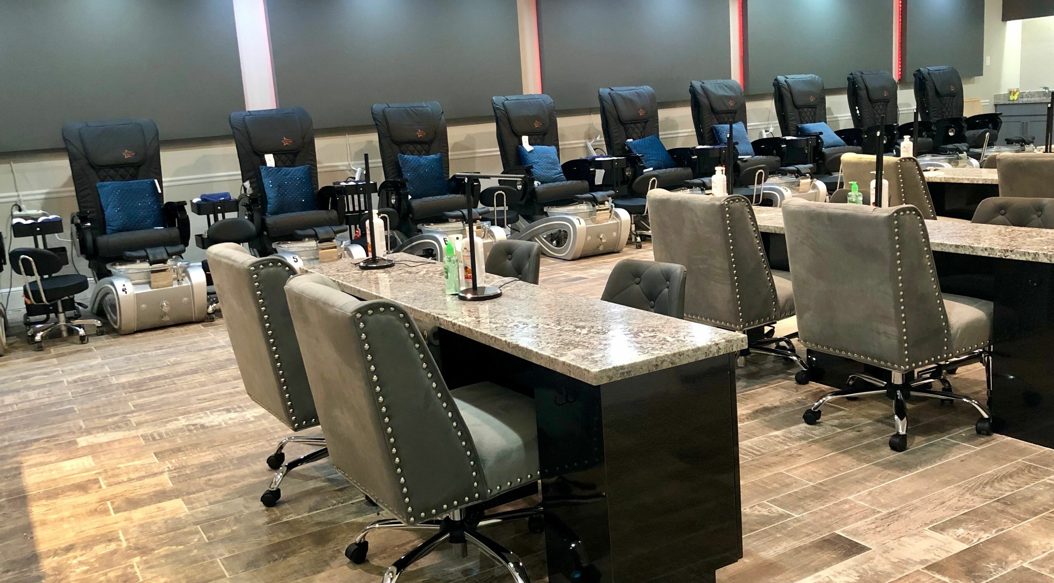 Upscale nail salon interior at Glo Nails, Houston, Texas, US featuring plush chairs and sleek nail stations.