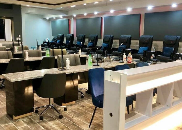 Modern nail salon interior at Glo Nails in Houston, Texas, US showcasing stylish manicure stations and seating.
