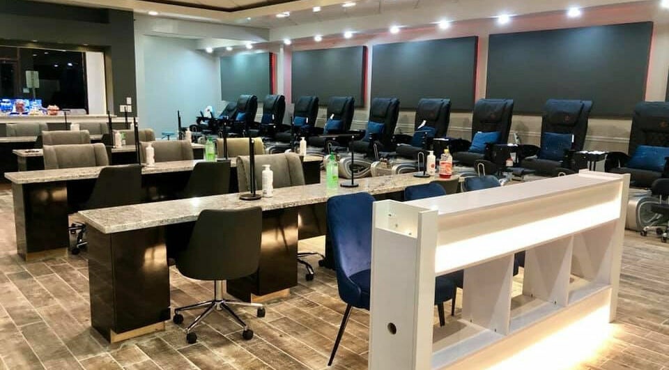 Modern nail salon interior at Glo Nails in Houston, Texas, US showcasing stylish manicure stations and seating.