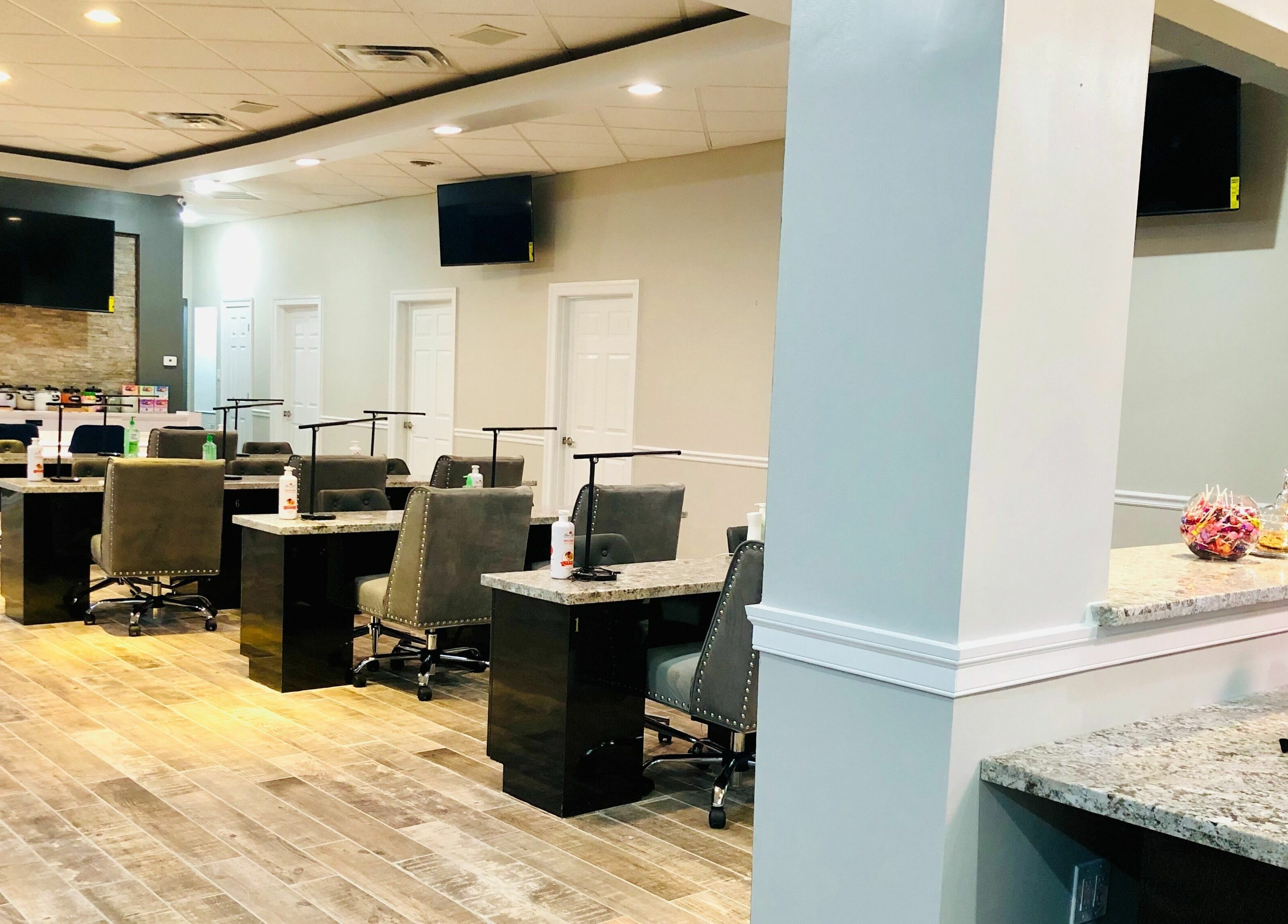 Modern interior of Glo Nails in Houston, Texas, US, featuring elegant nail stations and sleek decor.