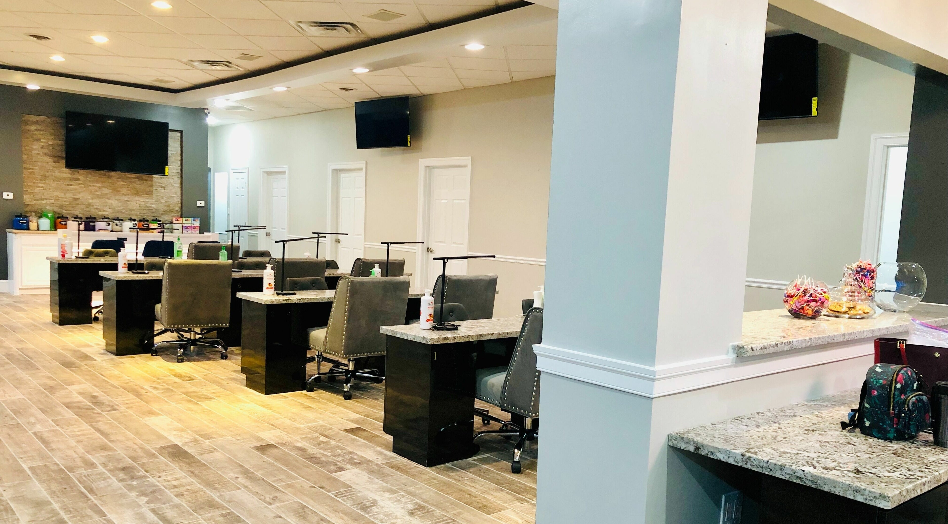 Modern interior of Glo Nails in Houston, Texas, US, featuring elegant nail stations and sleek decor.